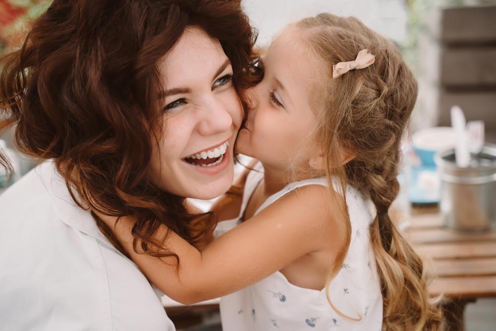 Portrait,Of,Little,Daughter,Kissing,Her,Beautiful,Happy,Mother